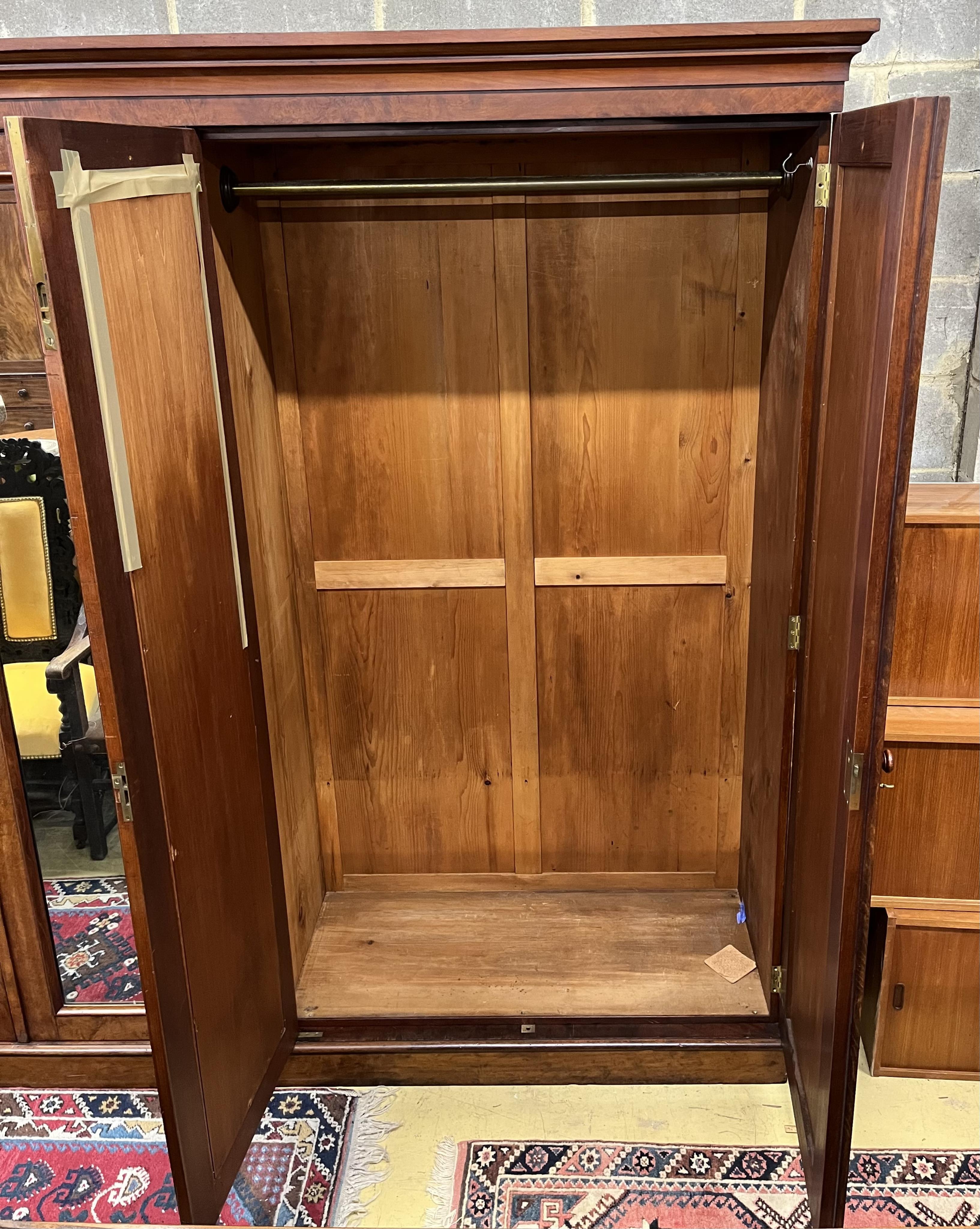 Lamb of Manchester, a Victorian mahogany mirrored compactum wardrobe, width 250cm, depth 58cm, height 231cm. Condition - fair to good